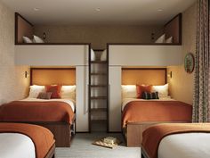 two beds in a small room with wooden headboards and orange blankets on the bed