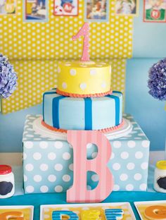 a colorful birthday cake sitting on top of a table