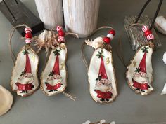 christmas ornaments are hanging on the table