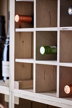 several bottles of wine are sitting on shelves