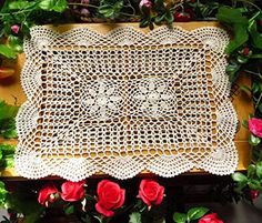 a crocheted doily with roses on it