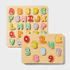 two wooden puzzles with letters and numbers on the front, one is multicolored