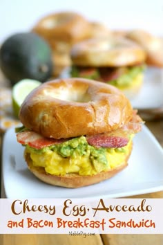 an egg avocado and bacon breakfast sandwich on a white plate