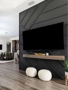 a large flat screen tv mounted to the side of a wall in a living room