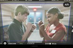 a television screen showing a man and woman in the middle of fist bumping each other