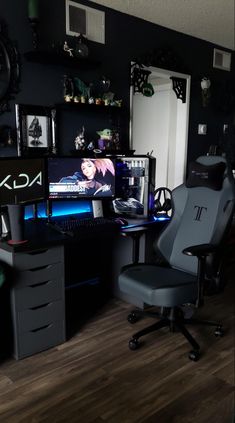 a computer desk with two monitors and a chair in front of it on top of a hard wood floor