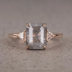 an engagement ring with a fancy diamond and three stone accents