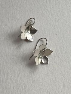 Pretty Sterling Silver Flower Earrings, Pretty Handmade Silver Blooms Beautiful hand hammered, domed and hand stamped Flower Earrings.  These are lightweight, easy to wear & elegant. Solid sterling  hammered botanical Earrings. These dangle from sterling silver hooks. Easy to wear and gift. Each pair comes with a pair of clear rubber backs. They will arrive in a pretty blue or green box with a hand stamped silver branch  design on it with a free polishing kit. Thanks! Earrings Handmade Silver, Briar Beauty, Sterling Silver Flower Earrings, Botanical Earrings, Silver Flower Earrings, Green Box, Flower Earring, Branch Design, Botanical Jewelry