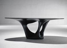 a black table sitting on top of a white floor