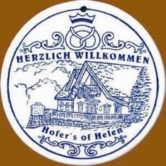 a blue and white sign that says herzich willkomen, hofer's of helle