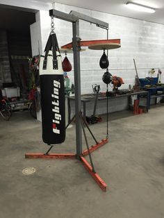 a gym with punching bags and equipment in it