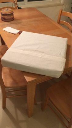 a wooden table with a mattress on top of it