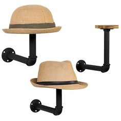 two hats mounted to the side of a wall with black pipe holders on each side