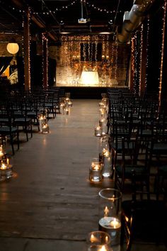 rows of chairs with lit candles in front of them