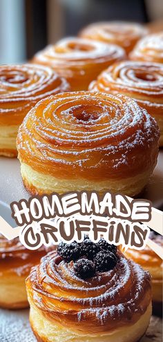 some doughnuts that are sitting on a table with the words homemade cruffins over them