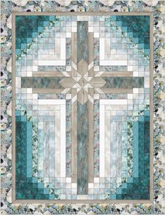 a large quilt with a cross on the center and flowers all around it, in shades of blue