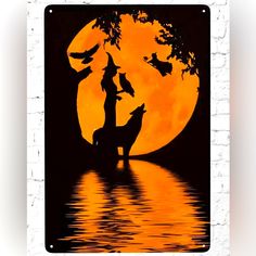 the silhouette of two people standing in front of a full moon with birds flying over them