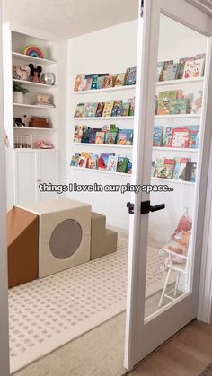 there is a cardboard box sitting on the floor in front of a book shelf with books