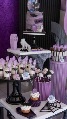 a table topped with lots of cupcakes and cakes