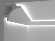 an empty room with white walls and lights on the ceiling is lit by bright lighting