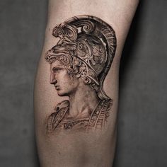 a black and white photo of a man's leg with a roman soldier tattoo on it