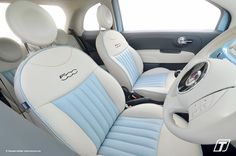 the interior of a car with blue and white leather