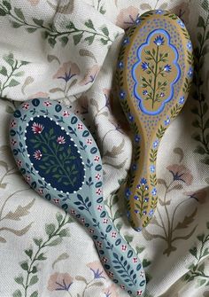 two wooden spoons sitting on top of a bed