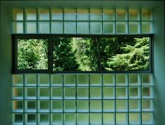 an open window with trees in the background