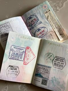 three passport papers with stamps on them