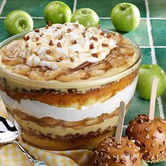 an apple dessert with caramel and whipped cream on top, apples in the background