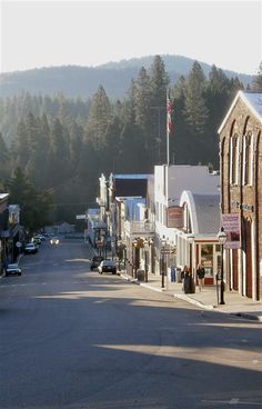 an empty street with cars parked on both sides