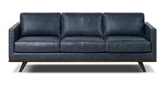 a blue leather couch with wooden legs