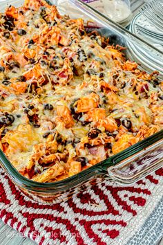 a casserole dish with cheese and black olives