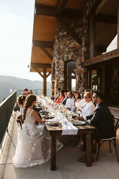 a group of people sitting at a table with plates and glasses in front of them