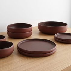 six brown plates on a wooden table