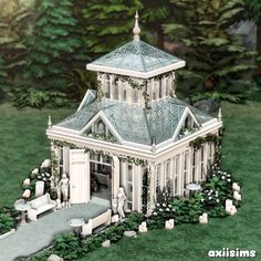 a model of a white house in the middle of some bushes and trees with people standing outside