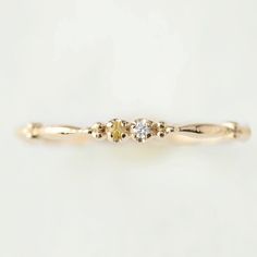 This dainty birthstone stackable ring is unlike any other, the band has a unique design all around which gives a bit of an antique feel. The perfect birthstone gift for your loved ones. Write out the two birthstones of your choice in the personalization box Two genuine 1.5mm gemstones Band width: approx. 1.75mm Material: 14k solid gold, rose gold, white gold Made of recycled precious metal and ethically sourced gemstone Packaged in a recyclable kraft ivory ring box <> January: Rhodolite Garnet F Dainty Promise Birthstone Ring With Rose Cut Diamonds, Gold Stackable Three Stone Rings For Promise, Gold Stackable Three-stone Rings For Promise, Delicate Stackable Birthstone Promise Ring, Gold Birthstone Three Stone Ring For Promise, Delicate Stackable Promise Birthstone Ring, Gold Three-stone Birthstone Ring For Promise, Delicate Promise Stackable Birthstone Ring, Dainty Birthstone Promise Ring With Rose Cut Diamonds