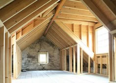 an attic with wood framing and exposed walls