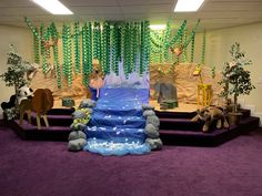 a stage set up for a children's birthday party with decorations and animals on it