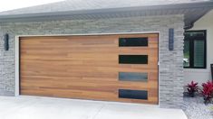 a wooden garage door in front of a house