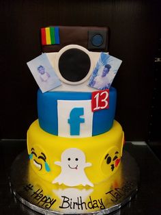 a birthday cake that is decorated with an instagramr and polaroid camera on top