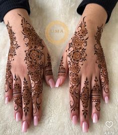 two hands with henna tattoos on them