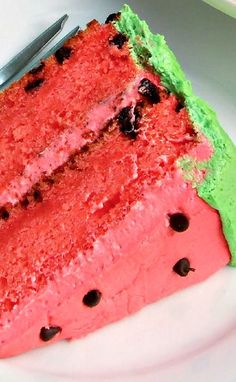 a slice of watermelon cake on a plate with a knife and fork next to it