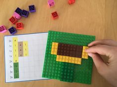 a person is playing with legos and building blocks to make a dog shape puzzle