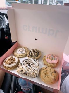 a box filled with lots of different types of cookies and doughnuts on top of a table