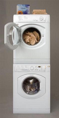 a stack of washers and dryers stacked on top of each other in front of a gray background