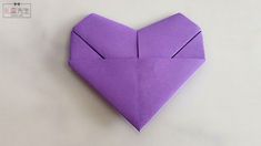 an origami heart shaped object sitting on top of a table