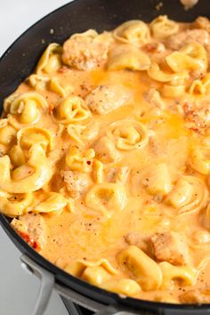 a skillet filled with pasta and meat