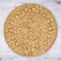 an intricately carved wooden plate with symbols on it's side, in the shape of a circle