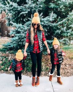 a woman and two children wearing winter clothes